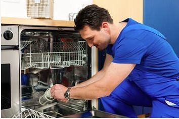 repairman fixing a dishwasher